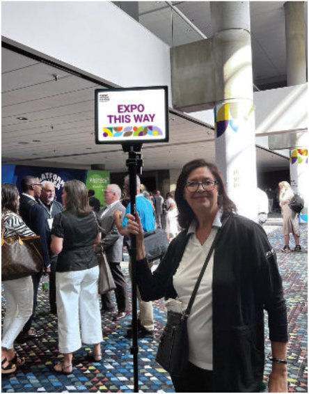 woman holding a sign on an expo