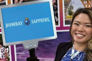 girl holding a blue sign