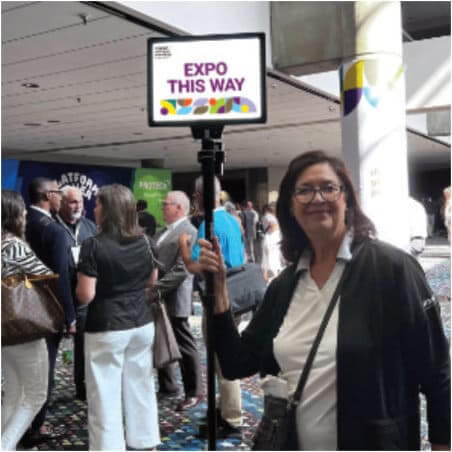 woman holding expo this way sign