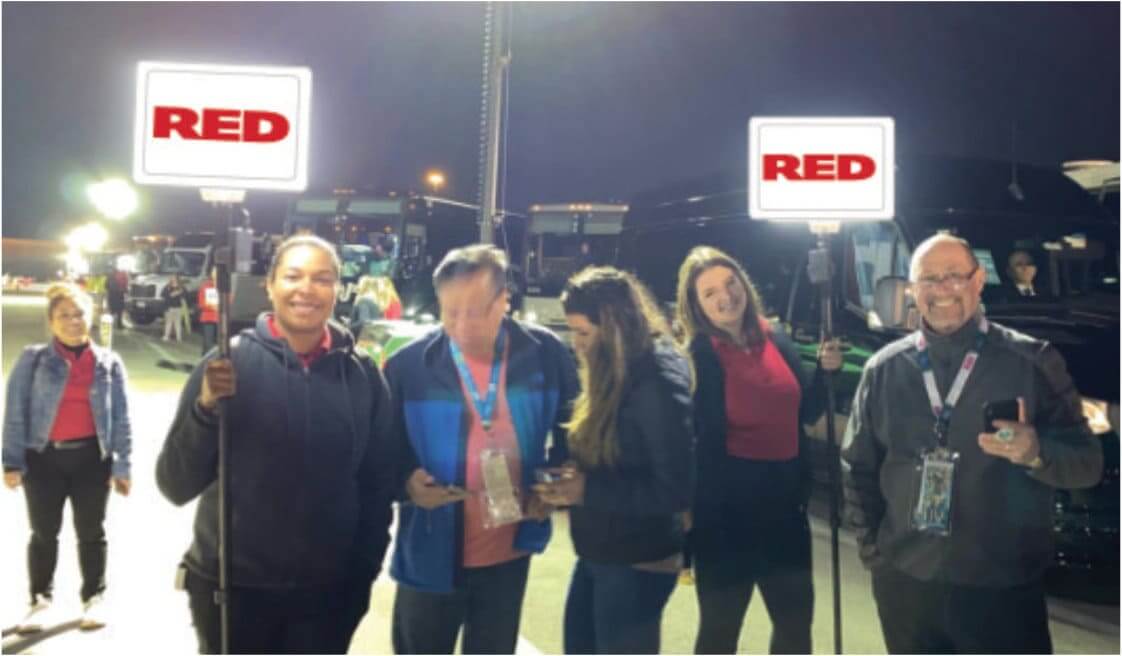 group of people holding a sign