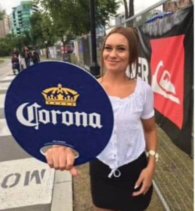 woman holding corona sign