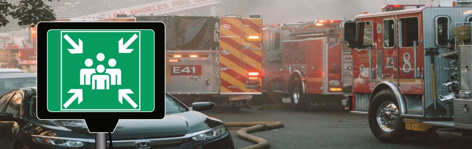 LED Muster Point Signs displayed in an emergency setting with fire trucks and vehicles in the background