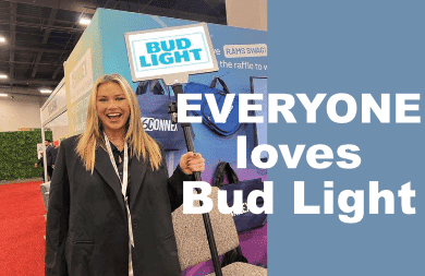 Woman holding a bud light sign