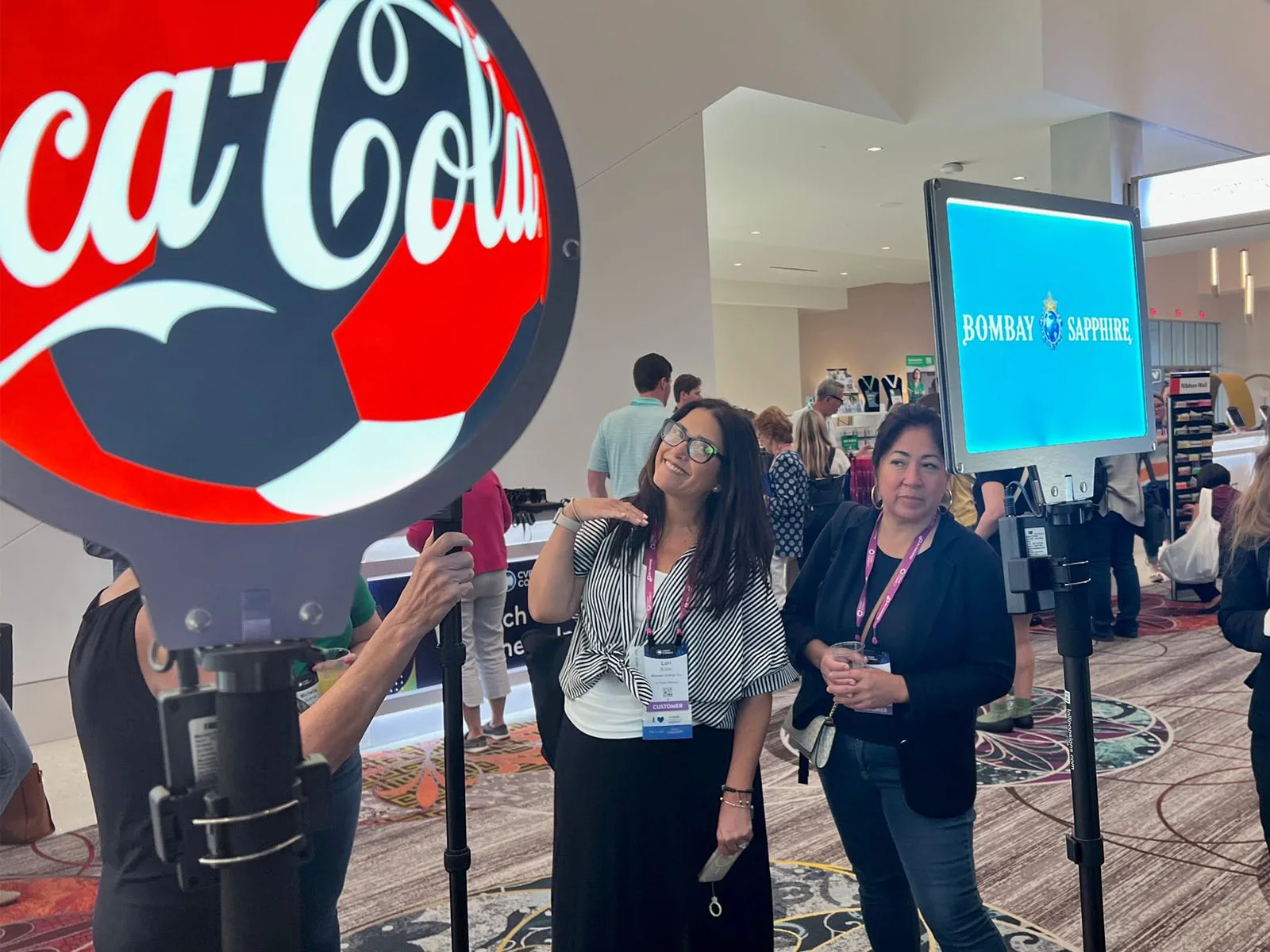 Lollipop Signs round and rectangular LED signs marking sponsor brand activations at a conference