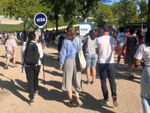 Lollipop Signs hand-held sign guiding spectators through the Olympic park at the Paris 2024 Olympics