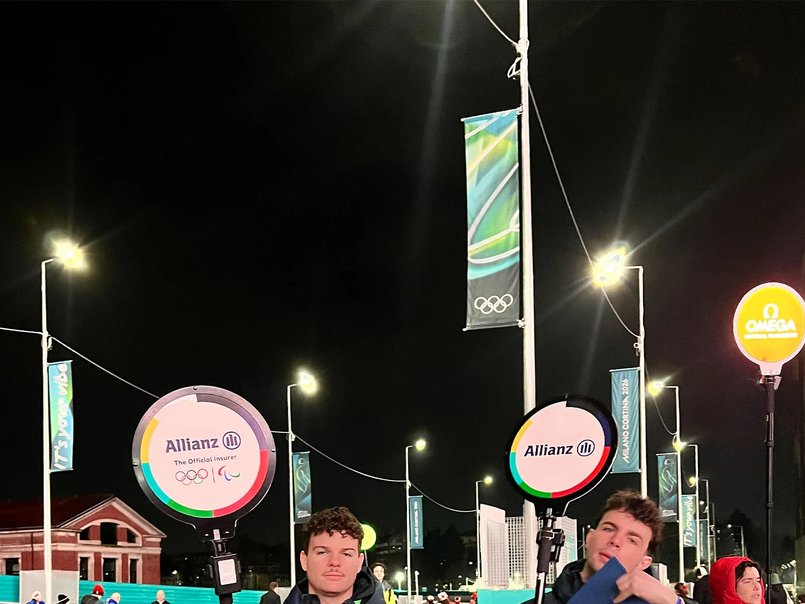 Lollipop Signs LED signs illuminating sponsor brand activations at night, 2026 Winter Olympics in Milano Cortina